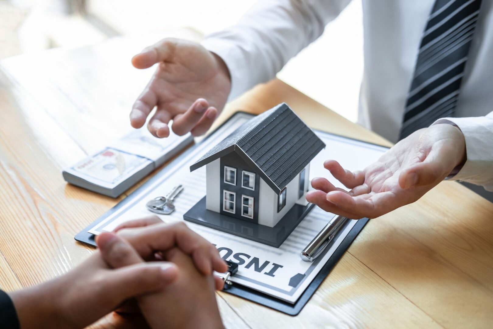 Estate agent are presenting home loan and giving house to client