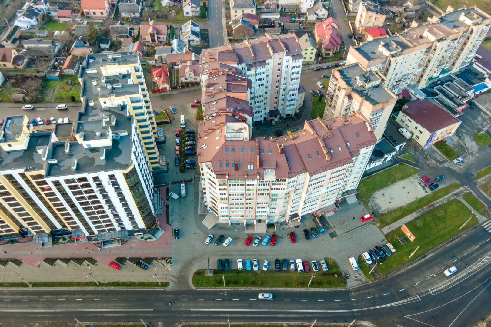 High rise apartment buildings and streets with traffic in city residential area.