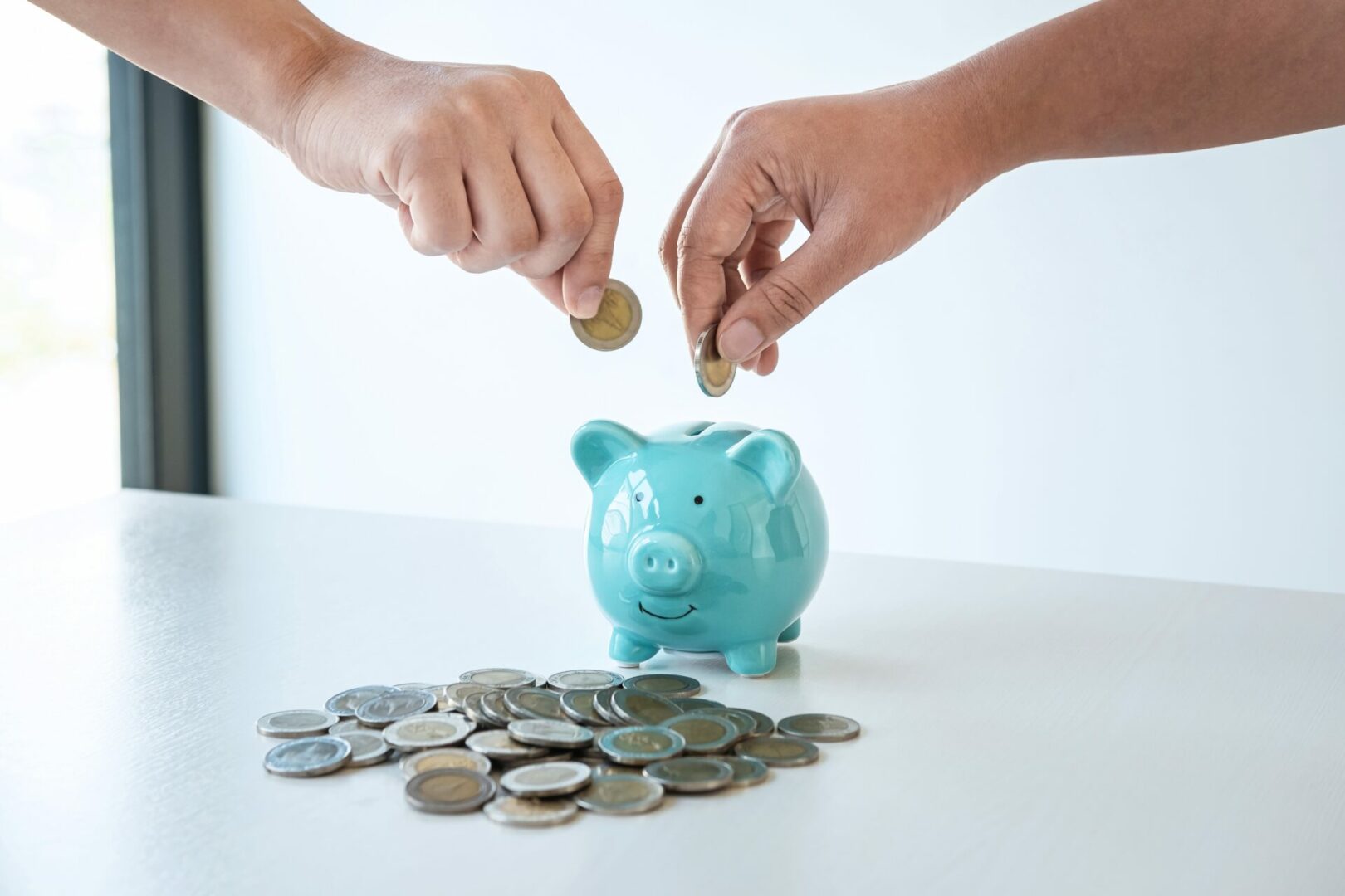 Image of hands putting coins into piggy bank planning growing sa
